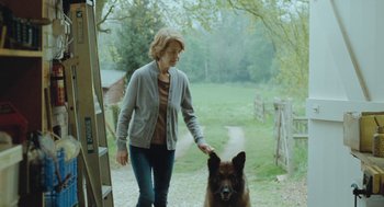 Movie still from “45 Years” (2015), directed by Andrew Haigh – A woman walking a dog on a leash; Medium shot, Over the shoulder angle