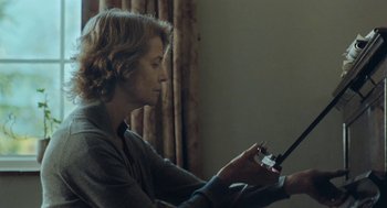 Movie still from “45 Years” (2015), directed by Andrew Haigh – A woman holding a cell phone in her hands; Medium shot, Low angle