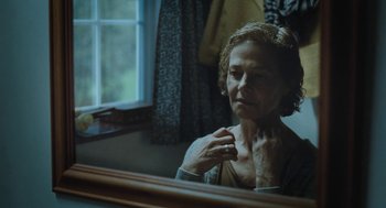 Movie still from “45 Years” (2015), directed by Andrew Haigh – An older woman looking in the bathroom mirror; Close Up shot, Over the shoulder angle