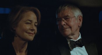 Movie still from “45 Years” (2015), directed by Andrew Haigh – An older man and a younger woman in formal wear; Close Up shot, Over the shoulder angle