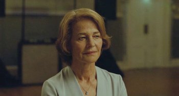 An older woman is looking into the distance