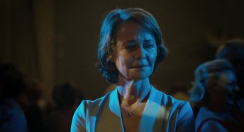 Movie still from “45 Years” (2015), directed by Andrew Haigh – An older woman is standing in the dark; Close Up shot, Over the shoulder angle