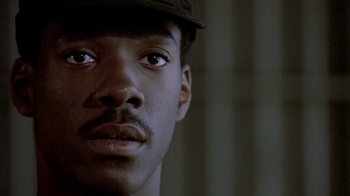 Movie still from “48 Hrs.” (1982), directed by Walter Hill – A person wearing a hat; Close Up shot, Low angle