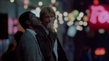 Movie still from “48 Hrs.” (1982), directed by Walter Hill – A couple of men standing next to each other; Close Up shot, Low angle