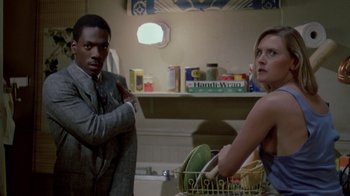 Movie still from “48 Hrs.” (1982), directed by Walter Hill – A man and a woman in a bathroom; Medium shot, Low angle