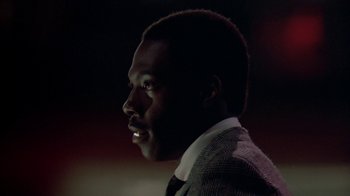 Movie still from “48 Hrs.” (1982), directed by Walter Hill – A person wearing a suit and tie; Close Up shot, Low angle