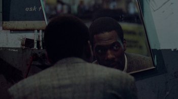 Movie still from “48 Hrs.” (1982), directed by Walter Hill – A man looking at himself in the mirror; Close Up shot, Over the shoulder angle