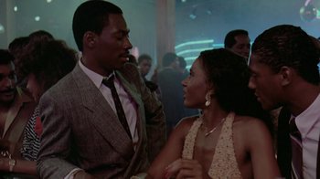 Movie still from “48 Hrs.” (1982), directed by Walter Hill – A man and a woman talking to each other in a room; Medium shot, Over the shoulder angle