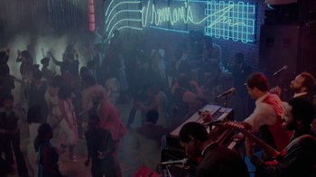 Movie still from “48 Hrs.” (1982), directed by Walter Hill – A group of people dancing in a room with neon lights; Extreme Wide shot, High angle