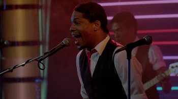 Movie still from “48 Hrs.” (1982), directed by Walter Hill – A man singing into a microphone in front of a crowd; Close Up shot, Low angle