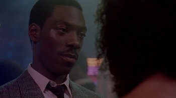 Movie still from “48 Hrs.” (1982), directed by Walter Hill – A person wearing a suit and a tie; Close Up shot, Over the shoulder angle