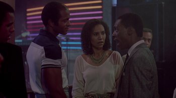 Movie still from “48 Hrs.” (1982), directed by Walter Hill – A group of people standing next to each other in a room; Medium shot, Over the shoulder angle