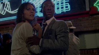 Movie still from “48 Hrs.” (1982), directed by Walter Hill – A man and a woman are standing in front of a neon sign; Close Up shot, Low angle