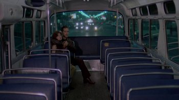 Movie still from “48 Hrs.” (1982), directed by Walter Hill – A man and a woman sitting on a bus together; Wide shot, High angle