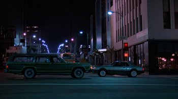 Movie still from “48 Hrs.” (1982), directed by Walter Hill – Two cars are stopped on a city street at night; Wide shot, Low angle