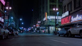 Movie still from “48 Hrs.” (1982), directed by Walter Hill – A city street at night lit by street lights; Extreme Wide shot, Low angle