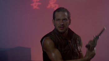 Movie still from “48 Hrs.” (1982), directed by Walter Hill – A person wearing a sleeveless shirt; Medium shot, Over the shoulder angle