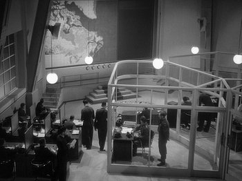 Movie still from “49th Parallel” (1941), directed by Michael Powell – A black and white photo of people in a room; Extreme Wide shot, High angle