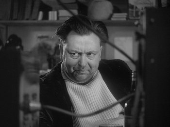 Movie still from “49th Parallel” (1941), directed by Michael Powell – A man with a beard and a sweater on looking at the camera; Close Up shot, Low angle
