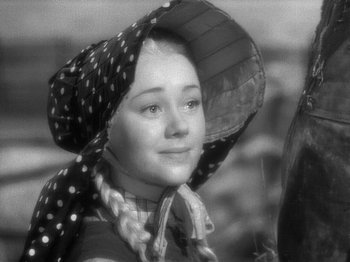 Movie still from “49th Parallel” (1941), directed by Michael Powell – A young girl wearing a polka dot hat and a scarf; Close Up shot, High angle