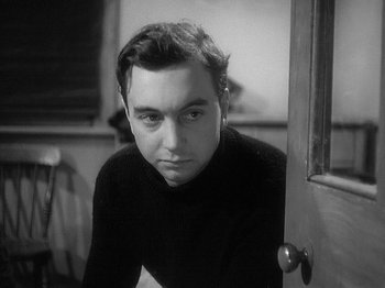 Movie still from “49th Parallel” (1941), directed by Michael Powell – Black and white photograph of a man in a sweater; Close Up shot, Low angle