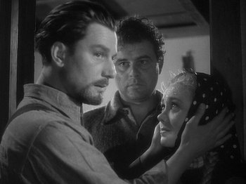 Movie still from “49th Parallel” (1941), directed by Michael Powell – A black - and - white photo of a man and two women; Close Up shot, Over the shoulder angle