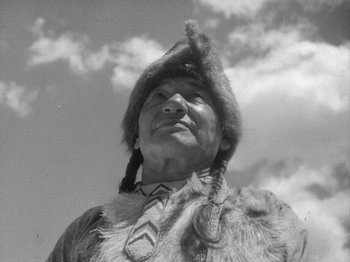 Movie still from “49th Parallel” (1941), directed by Michael Powell – An old photograph of an older man wearing a hat; Close Up shot, Low angle