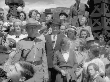 Movie still from “49th Parallel” (1941), directed by Michael Powell – A group of people standing in front of each other wearing hats; Wide shot, Low angle