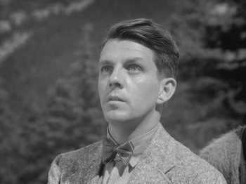 Movie still from “49th Parallel” (1941), directed by Michael Powell – A man in a suit and a bow tie; Close Up shot, Low angle