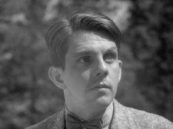 Movie still from “49th Parallel” (1941), directed by Michael Powell – A young man in a suit and bow tie looking to his left; Close Up shot, Low angle