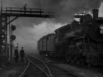 Movie still from “49th Parallel” (1941), directed by Michael Powell – A black and white photo of a steam train; Extreme Wide shot, Low angle