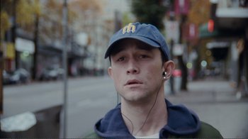 Movie still from “50/50” (2011), directed by Jonathan Levine – A young man wearing headphones and a baseball cap; Close Up shot, High angle