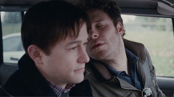Movie still from “50/50” (2011), directed by Jonathan Levine – Two young men in the back seat of a car; Close Up shot, Over the shoulder angle