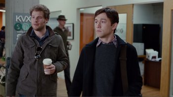Movie still from “50/50” (2011), directed by Jonathan Levine – Two men are walking down a hallway holding a cup of coffee; Medium shot, Over the shoulder angle