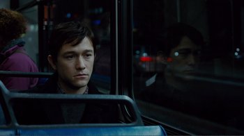 Movie still from “50/50” (2011), directed by Jonathan Levine – A man sitting on a bus looking out the window; Close Up shot, Over the shoulder angle