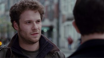 Movie still from “50/50” (2011), directed by Jonathan Levine – A man with a beard is talking to another man; Close Up shot, Over the shoulder angle
