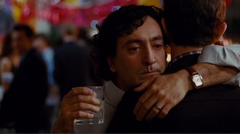 Movie still from “50/50” (2011), directed by Jonathan Levine – A man hugging another man holding a drink; Close Up shot, Over the shoulder angle