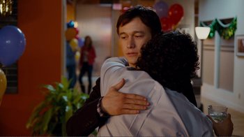 Movie still from “50/50” (2011), directed by Jonathan Levine – A man and a woman hugging each other in front of balloons; Close Up shot, Over the shoulder angle