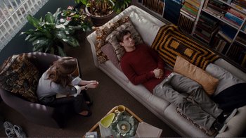 Movie still from “50/50” (2011), directed by Jonathan Levine – A man and a woman sitting on a couch in a living room; Wide shot, High angle