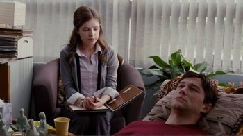 Movie still from “50/50” (2011), directed by Jonathan Levine – A young woman sitting in a chair while a man lies in bed; Medium shot, Over the shoulder angle