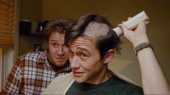 Movie still from “50/50” (2011), directed by Jonathan Levine – A man is getting his hair cut by another man; Close Up shot, High angle