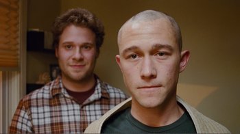 Movie still from “50/50” (2011), directed by Jonathan Levine – Two men standing next to each other in front of a wall; Close Up shot, Over the shoulder angle