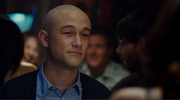 Movie still from “50/50” (2011), directed by Jonathan Levine – A man with a bald head is smiling for the camera; Close Up shot, Over the shoulder angle