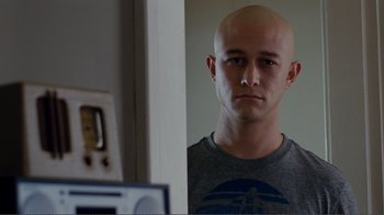 Movie still from “50/50” (2011), directed by Jonathan Levine – A man with a shaved head looking at himself in the mirror; Close Up shot, Low angle