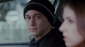 Movie still from “50/50” (2011), directed by Jonathan Levine – A man in a black jacket and a black and white striped hat; Close Up shot, Over the shoulder angle