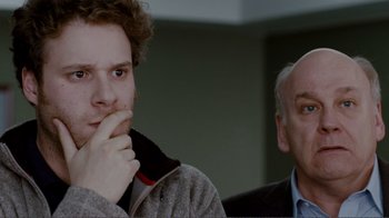 Movie still from “50/50” (2011), directed by Jonathan Levine – A young man and an older man are looking at the camera; Close Up shot, Over the shoulder angle