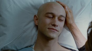 Movie still from “50/50” (2011), directed by Jonathan Levine – A man laying in bed with his head on a pillow; Close Up shot, Overhead angle