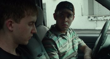 Movie still from “600 Miles” (2015), directed by Gabriel Ripstein – Two men sitting in the back seat of a car; Close Up shot, Over the shoulder angle