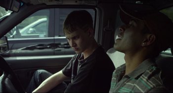 Movie still from “600 Miles” (2015), directed by Gabriel Ripstein – Two young men sitting in the back seat of a car; Medium shot, Over the shoulder angle