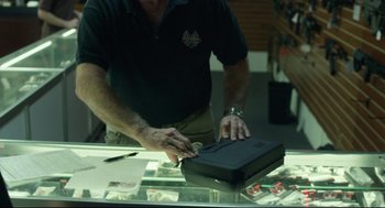 Movie still from “600 Miles” (2015), directed by Gabriel Ripstein – A man is cutting a piece of paper with a knife; Close Up shot, High angle